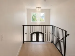 Level 4/5 finished walls and ceiling in a stairwell, for an ultra-smooth, imperfection-free surface.