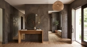 Deep charcoal-taupe Tadelakt plaster walls in a modern entryway hallway with a round mirror, Santa Clara, CA