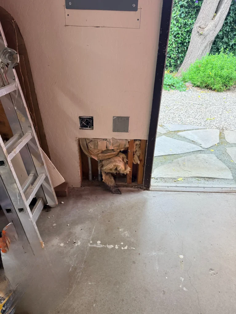 A neat hole cut into a drywall wall, prepared for a new patch to be installed.