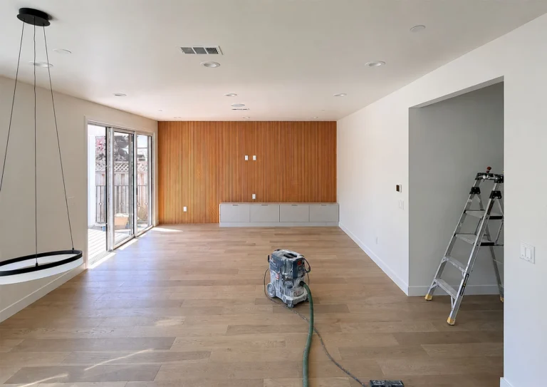 New drywall, flooring, and built-in millwork going in during a whole-room renovation.