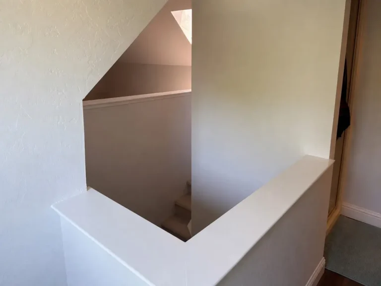 Half-wall at the stair opening extended to the ceiling to enclose a loft room in a San Jose home