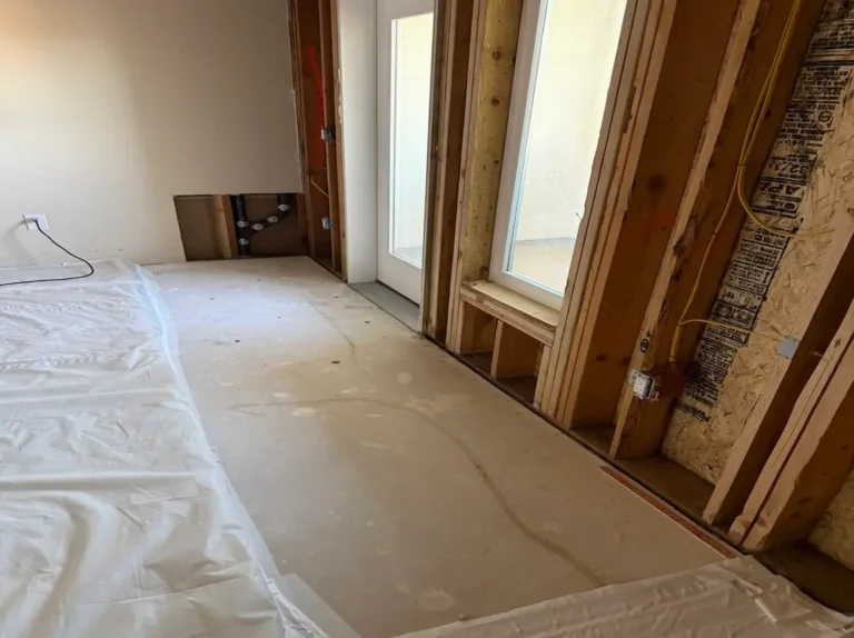 Water damage drywall repair in a San Jose home: wet drywall removed down to the studs around the windows after mitigation, ready for rebuild