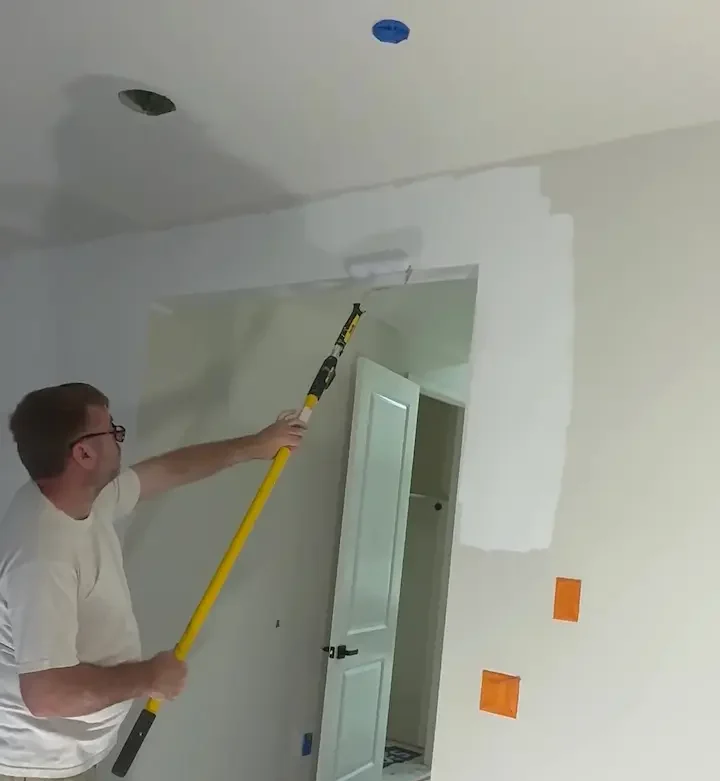 Sergei priming walls and ceiling before painting in San Jose