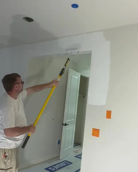 Sergei priming walls and ceiling before painting in San Jose