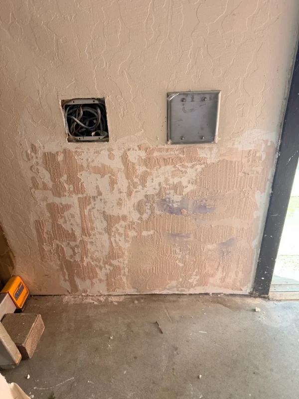 The completed drywall repair. The patch is taped, floated, and the texture is blended to match the existing wall, ready for paint.